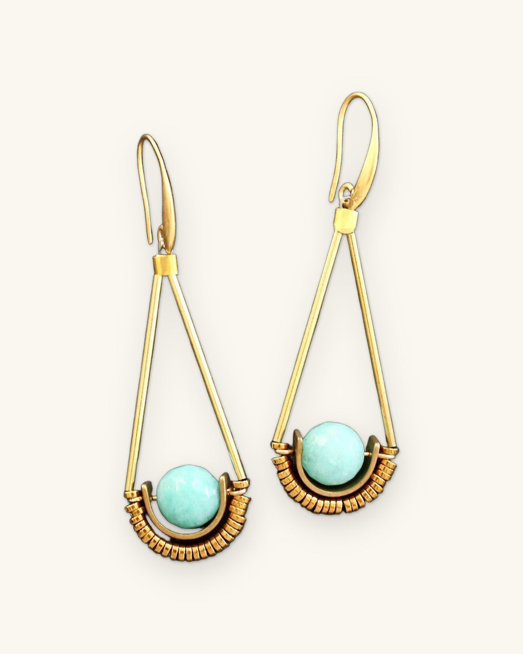 Amazonite sphere drop earrings in long gold triangle frames, hand-wrapped wire made in the USA, on black slate, shown on a sand background