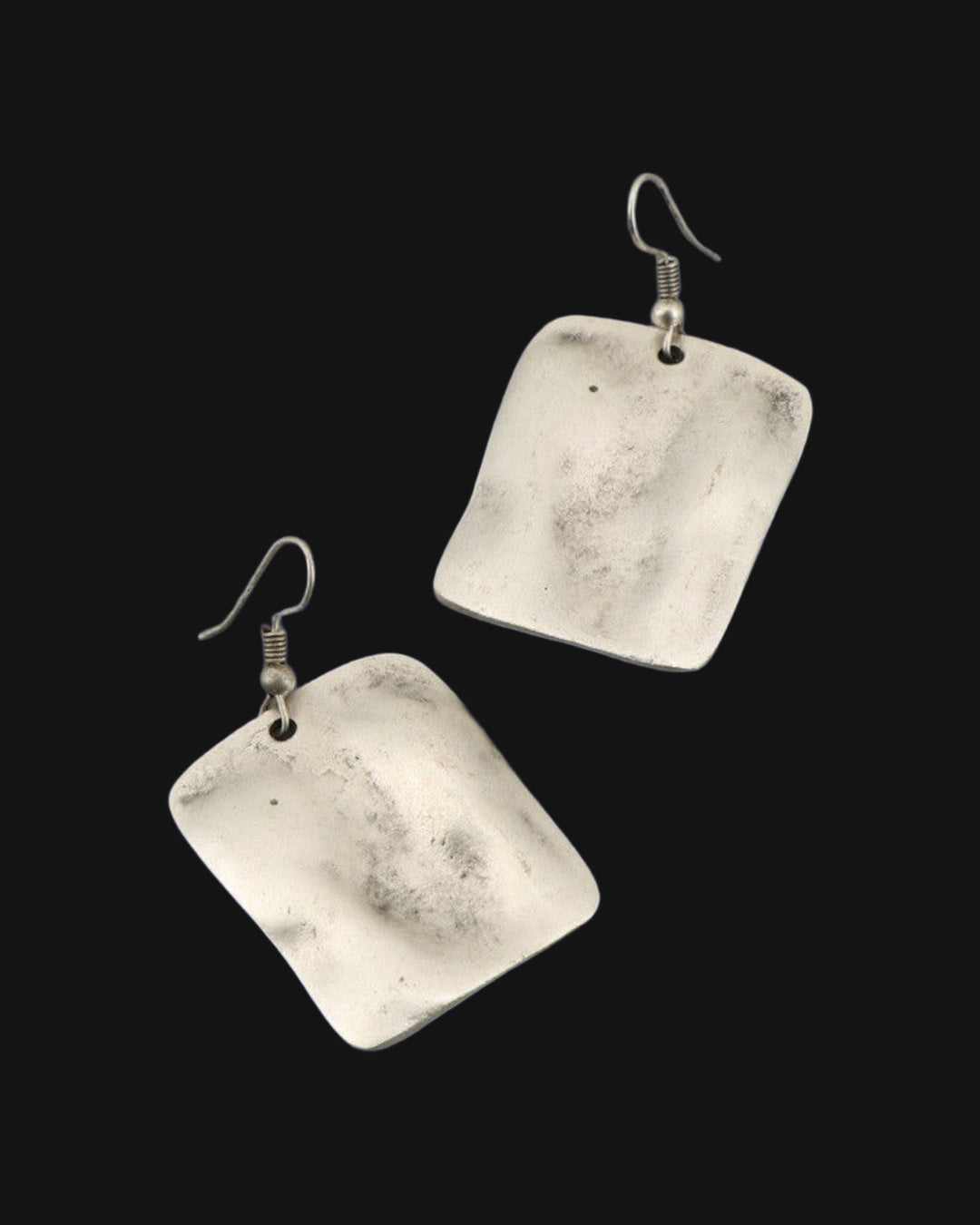 Pair of brushed silver-tone rectangle earrings with a rippled wave surface on fish-hook ear wires, shown on a black background