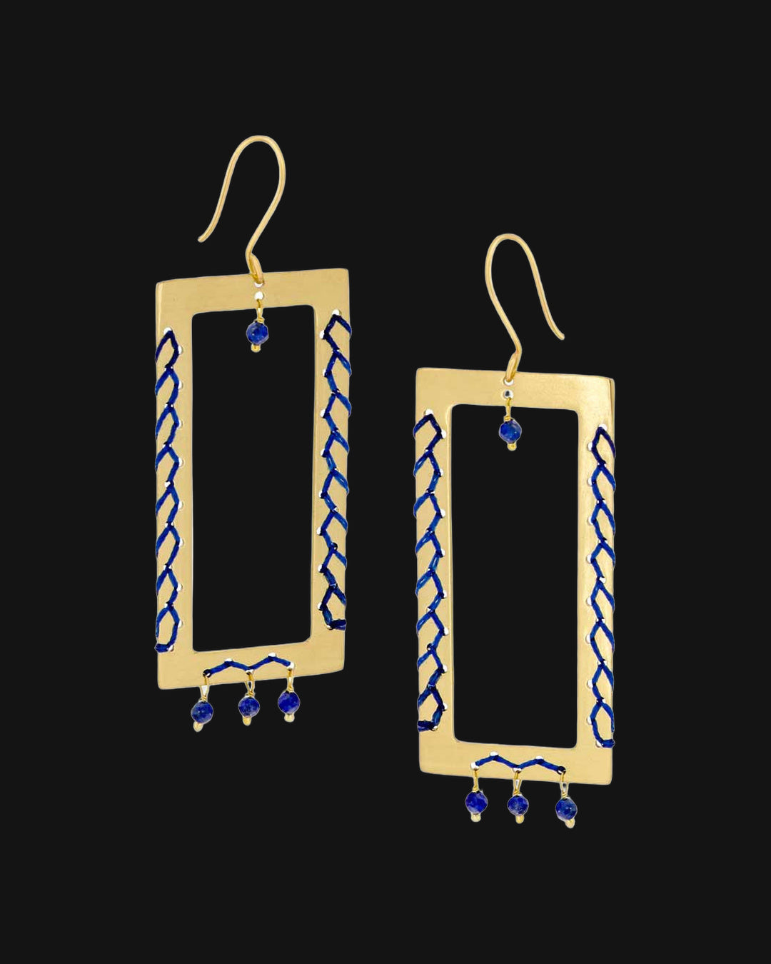 Brass rectangle frame earrings laced with cobalt cord and lapis lazuli bead drops, handmade in India, shown on a black background