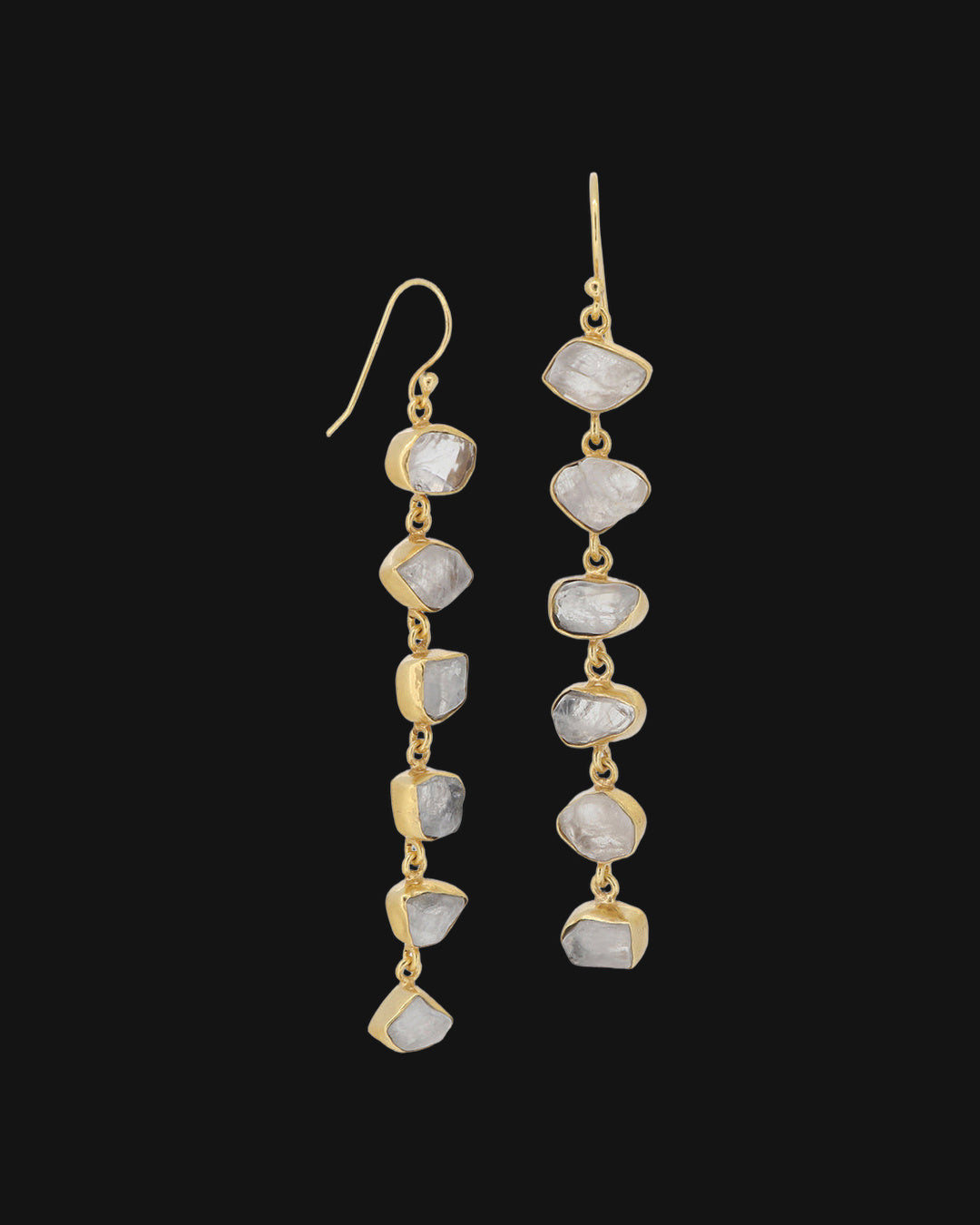 Raw rainbow moonstone column drop earrings with bezel-set stones in gold-plated brass, made in India, shown on a black background