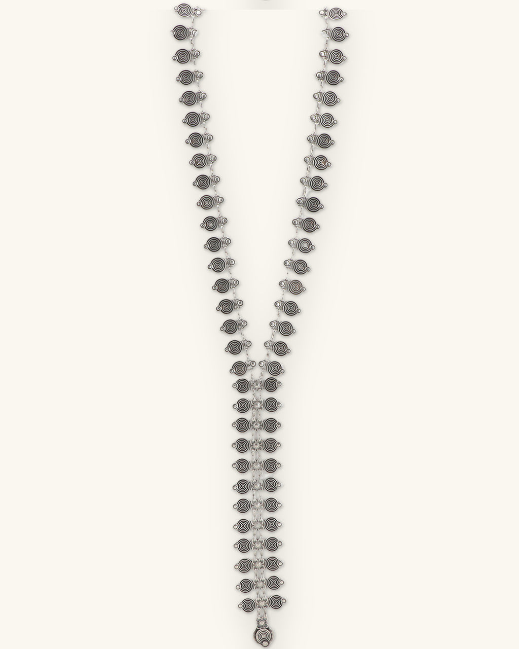 Spiral-stamped silver Y-drop necklace, straight front view ending in a small teardrop, shown on a sand background
