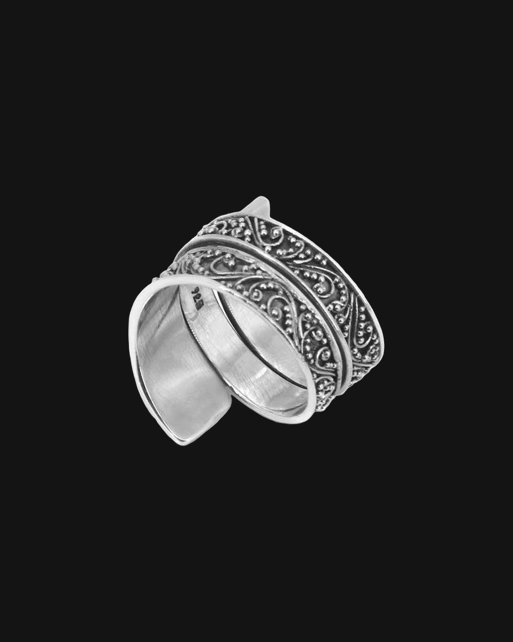 Sterling silver wide band filigree ring with scroll and granulation work, handmade in Bali, Indonesia, shown on a black background