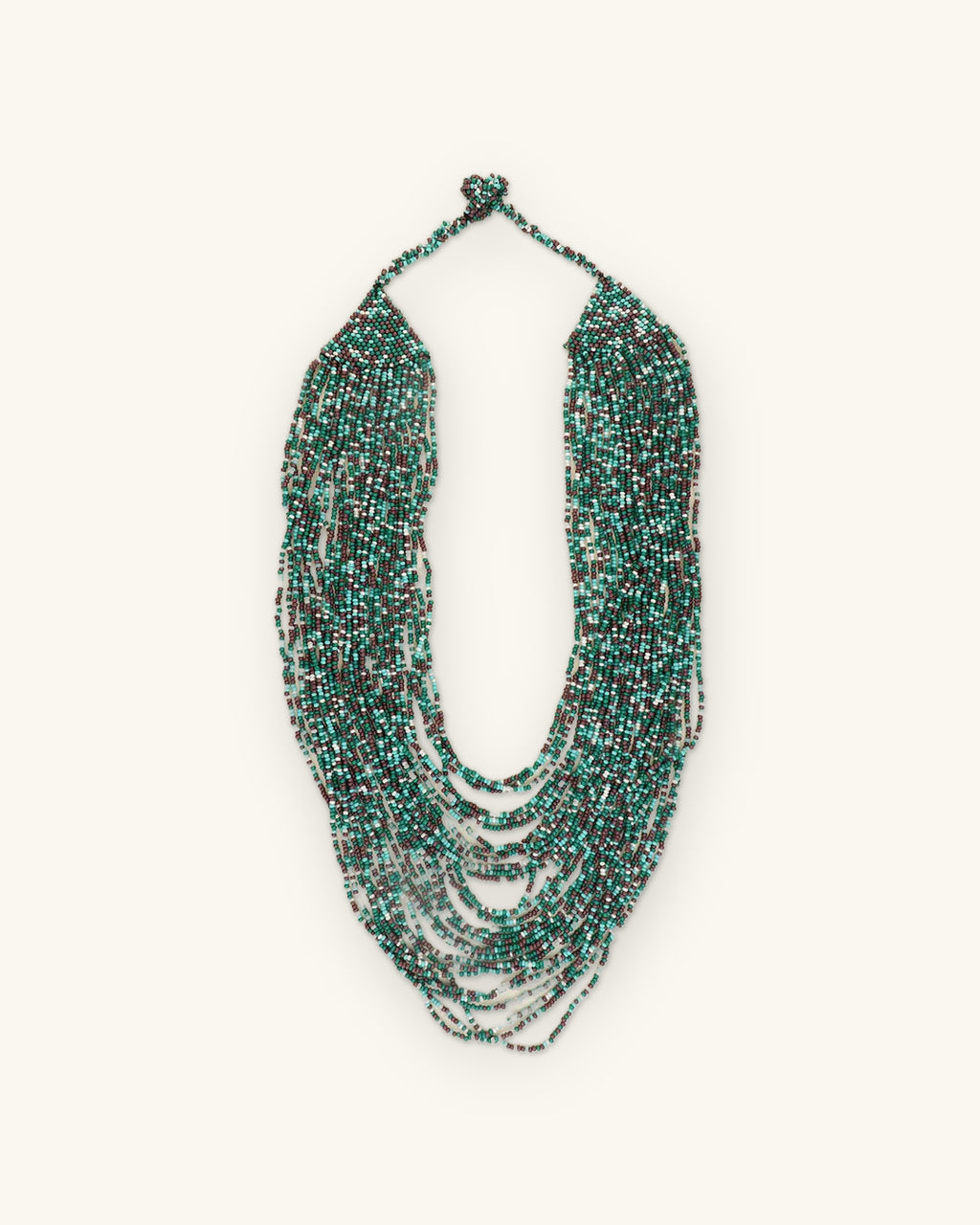 Cascading multi-strand glass seed bead bib necklace in teal, turquoise and gray, made in India, shown on a sand background