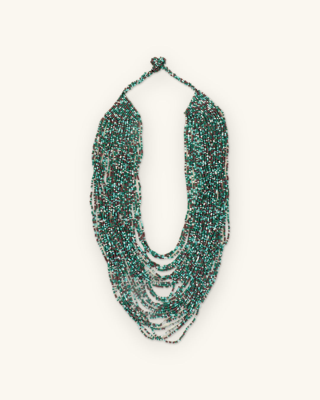 Cascading multi-strand glass seed bead bib necklace in teal, turquoise and gray, made in India, shown on a sand background