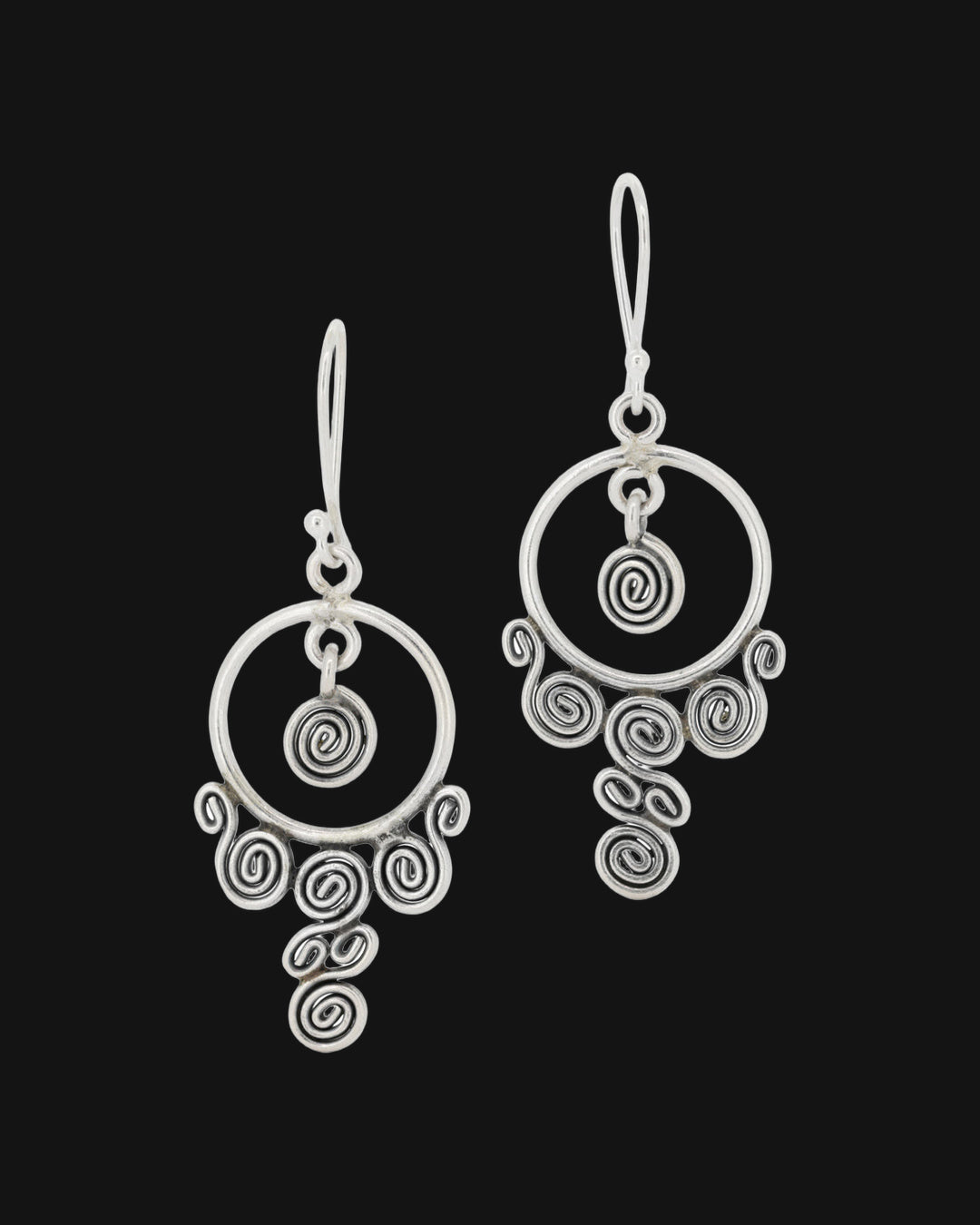 Silver chandelier earrings with an open hoop, center spiral and cascading coiled spirals, front view, shown on a black background
